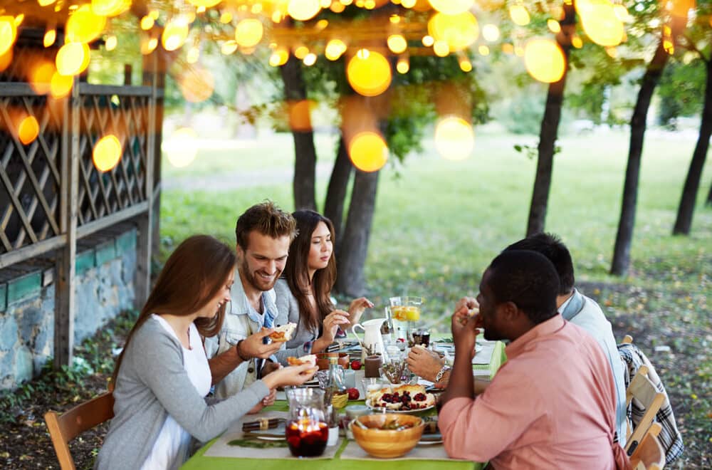 Friends celebrating Thanksgiving at a table in fall